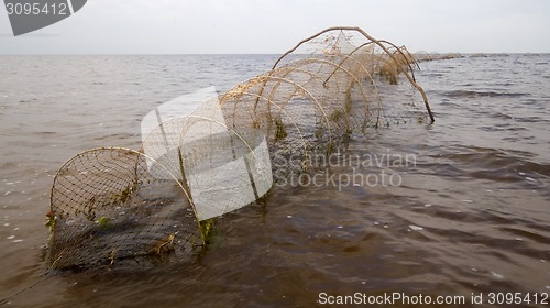 Image of fishing net  a fish-trap on lake