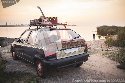 Image of Old rusted hippie car freedom concept on coast