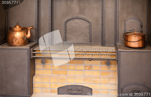 Image of big stove with old copper utensils