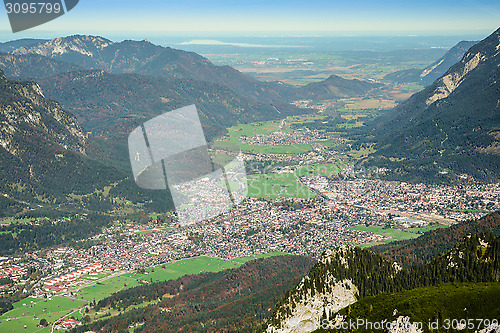 Image of Green valley with small town in Alps mountains 