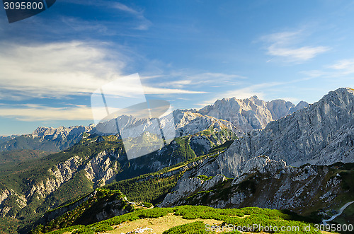 Image of Alps sunlight high mountains peaks with green valley and blue sk