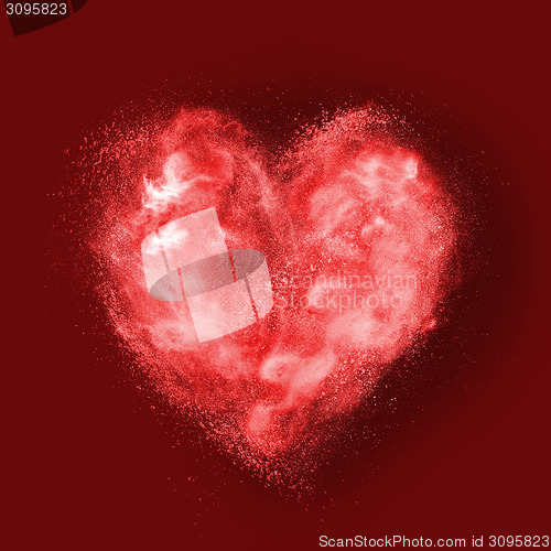 Image of heart made of powder explosion on red