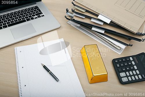 Image of a gold bar on desk