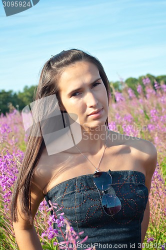 Image of Beautiful brunette woman in field