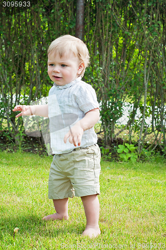 Image of Baby boy doing first steps