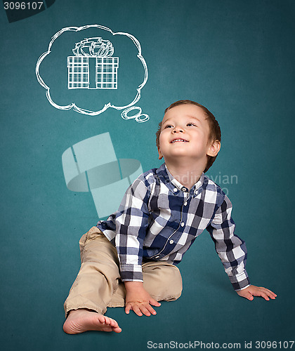 Image of Cute boy siting on the floor