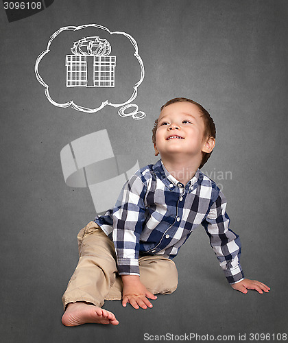 Image of Cute boy siting on the floor