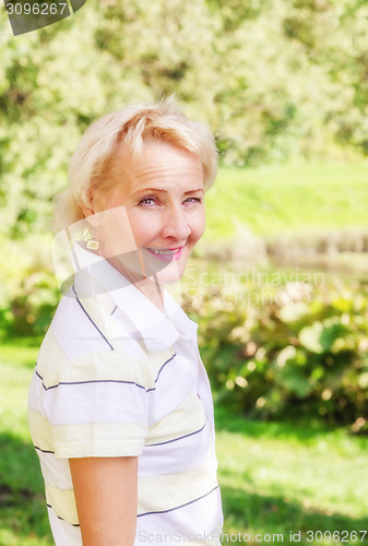 Image of Portrait of a middle-aged woman in a park on a sunny day