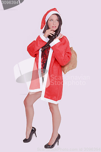 Image of Thoughtful woman in lingerie with Santa Claus costume and bag