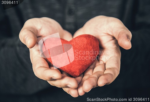 Image of man holding red heart 