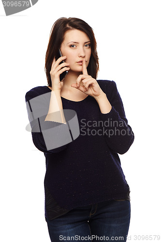 Image of Businesswoman gesturing finger on lips