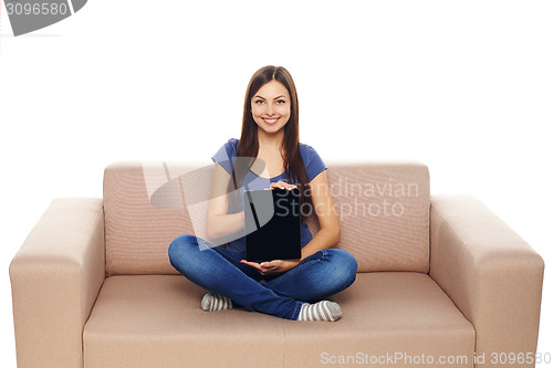 Image of Woman with tablet on sofa