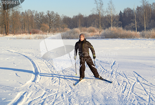 Image of Boy cross country skiing at sunny winter day