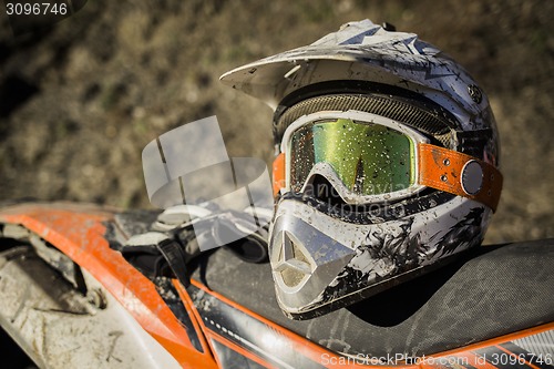 Image of Dirty motorcycle motocross helmet with goggles