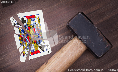 Image of Hammer with a broken card, jack of clubs