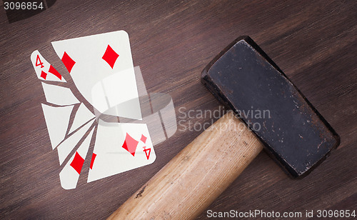 Image of Hammer with a broken card, four of diamonds