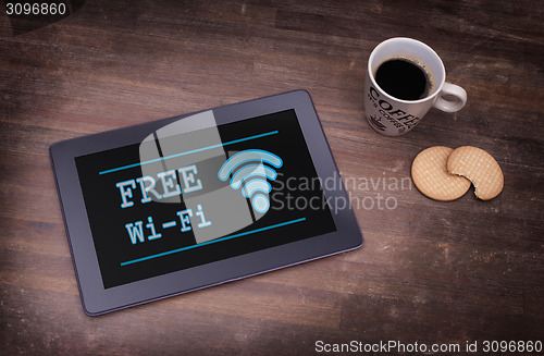 Image of Tablet with Wi-Fi connection on a wooden desk