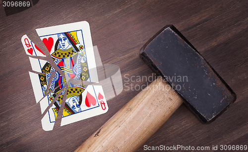 Image of Hammer with a broken card, queen of hearts