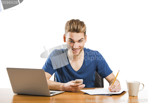 Image of Young man sending text messages