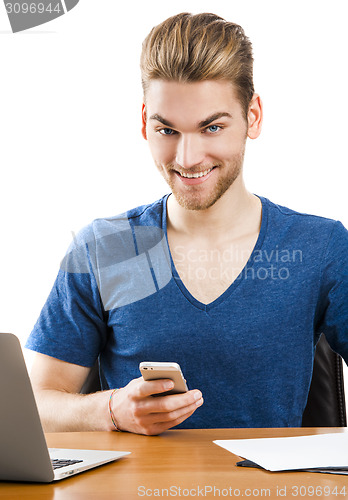 Image of Young man sending text messages