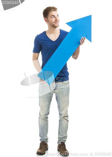 Image of Young man holding a blue arrow