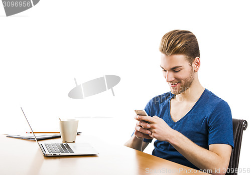 Image of Young man sending text messages