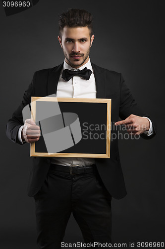 Image of Young man holding a chalkboard