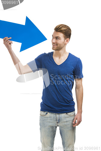 Image of Young man holding a blue arrow