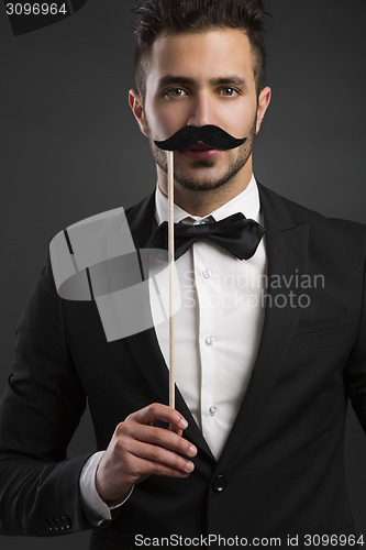 Image of Holding a fake mustache