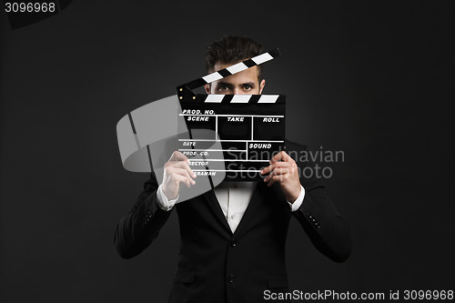 Image of Business man holding a clapboard