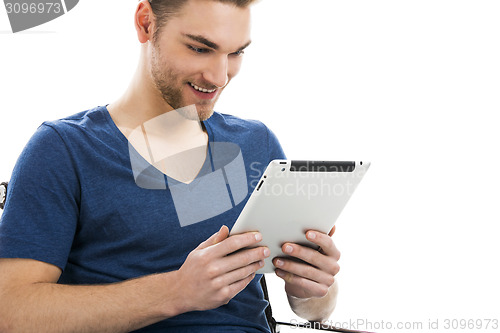 Image of Young man working with a tablet