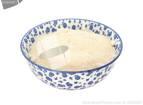 Image of Golden caster sugar in a blue and white china bowl