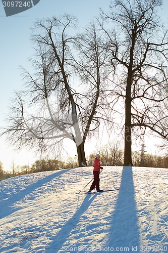 Image of Girl enjoying cross-country skiing running up in sunny day