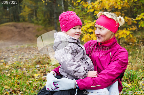 Image of Grandmother with her granddaughter in the autumn park