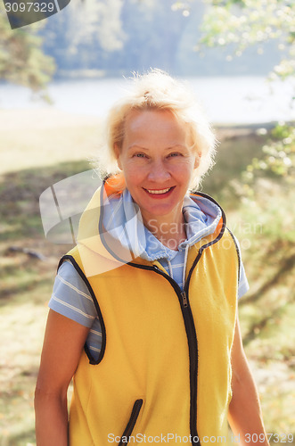 Image of Portrait of a middle-aged woman in a park on a sunny day