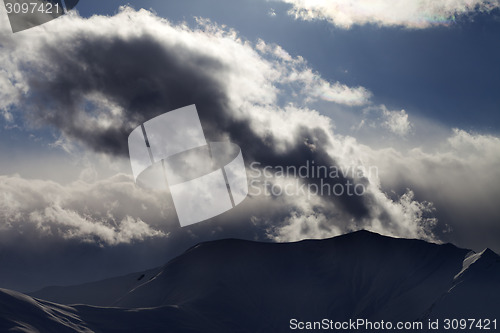 Image of Evening dark mountain and sunlight clouds