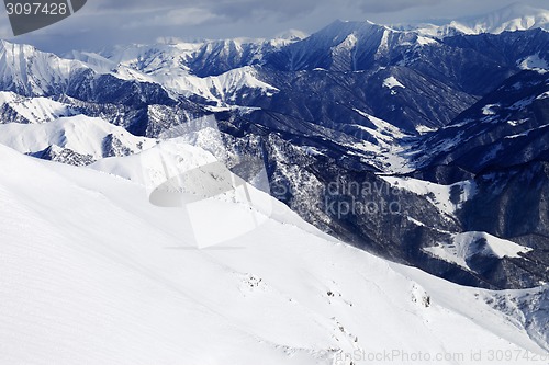 Image of Off-piste slope and snowy mountains