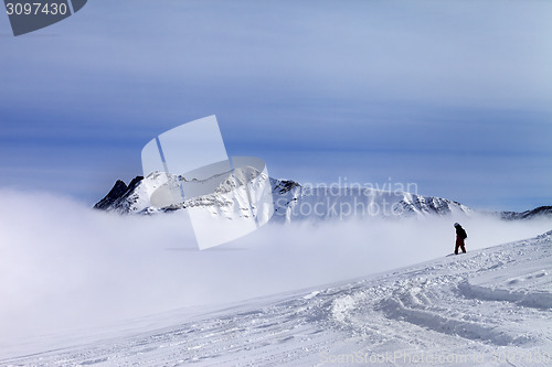 Image of Snowboarder on off-piste slope with newly fallen snow