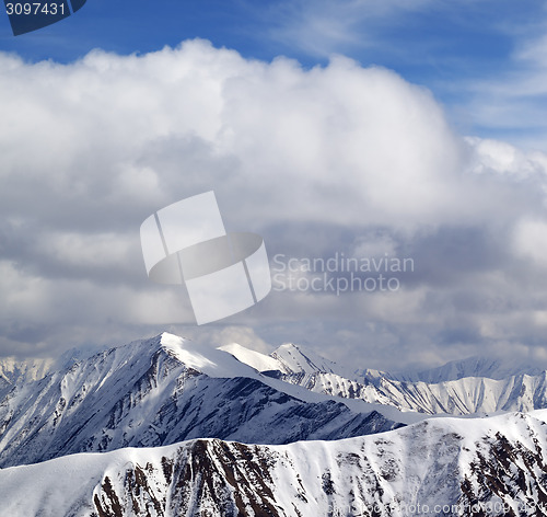 Image of Winter snowy mountains and sky with clouds at nice day