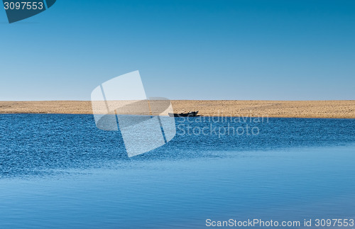 Image of Solo Rowboat Moored on Sandy Beach