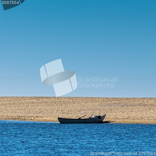 Image of Solo Rowboat Moored on Sandy Beach