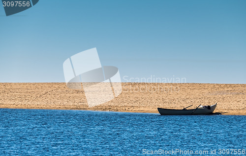 Image of Solo Rowboat Moored on Sandy Beach