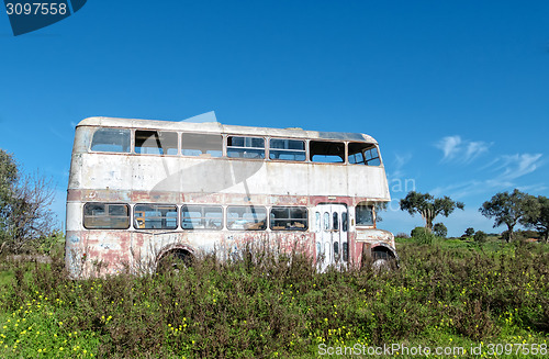 Image of Rusty Abandoned Double-Decker Bus Standing in a Field