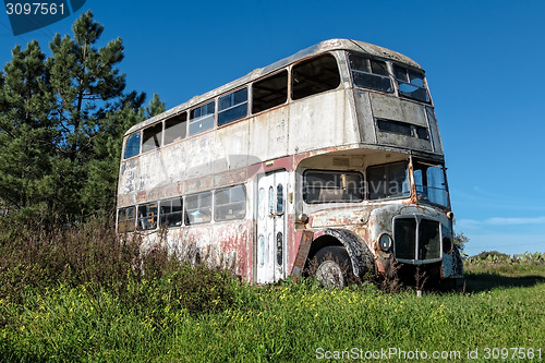 Image of Rusty Abandoned Double-Decker Bus Standing in a Field