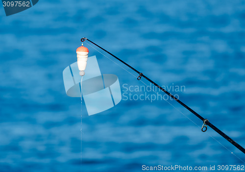 Image of Fishing Bait-Rod with Float against the Blue Sea Water Surface