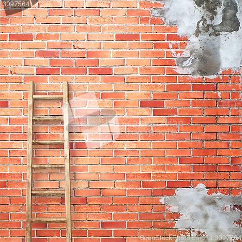 Image of red brick wall with wooden ladder