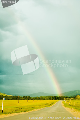 Image of Rainbow above road in Mountain Altai. Russia