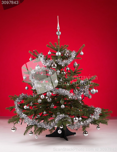 Image of Decorated christmas tree on red background