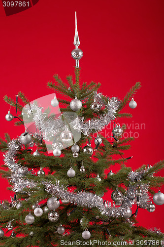 Image of Decorated christmas tree on red background