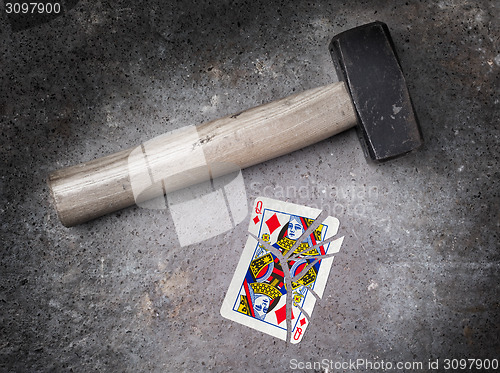 Image of Hammer with a broken card, queen of diamonds